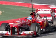 Red Ferrari formula one racing car during the Italian F1 Grand Prix in sunlight