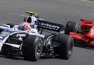Black racing car followed by a red Ferrari at the Russian Formula 1 Grand Prix Sotchi