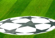 Green football field of the UEFA Super Cup in Tbilisi with the logo in the center