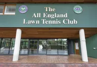 Roger Federer serving on a green grass court at the Wimbledon tennis tournament in London England