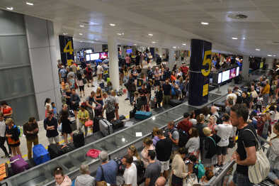 Chaos at Manchester airport T3 where an earlier evacuation caused baggage reclaim waiting times to exceed 4 hours. Hundreds of stranded passengers with no bags