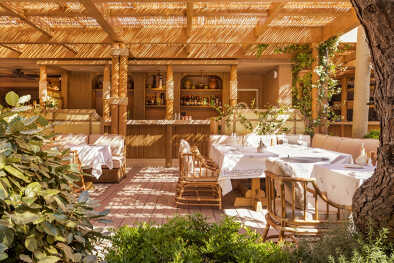 Experience Italian culinary delights in the serene outdoor dining area of Gigi Ramatuelle, nestled amidst the pine forest in St. Tropez.