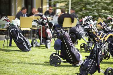 Golf caddies and clubs parked outside a golf club restaurant Golf caddies and clubs parked outside a golf club restaurant