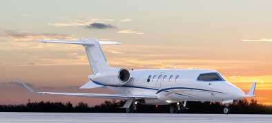 An elegant mid-size private jet at sunset ready for takeoff