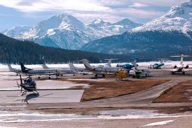 View of the airport of Samedan with private jets and a helicopter