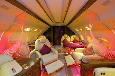 Interior cabin of a private jet with coloured celebratory lighting